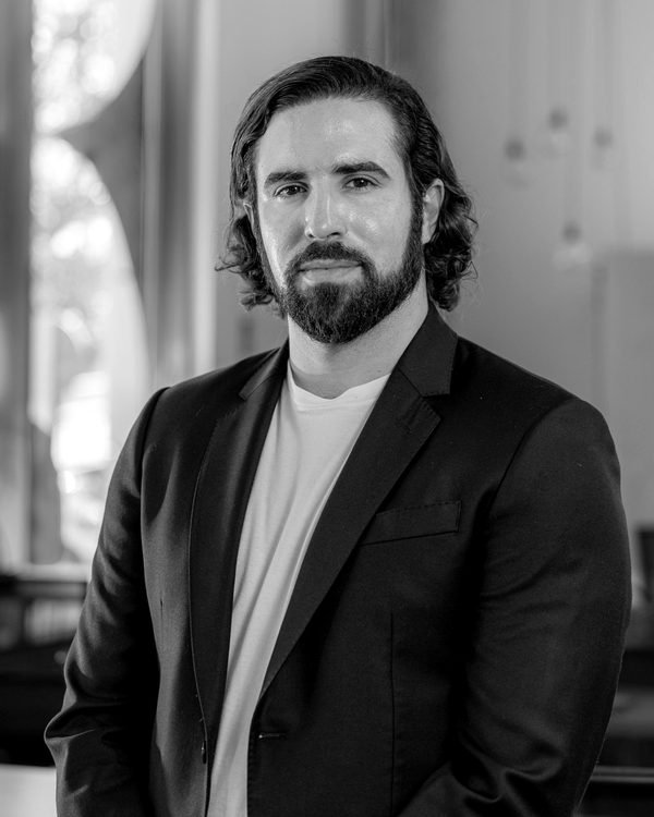 Alfonso Medela in a dark blazer, in a bright office