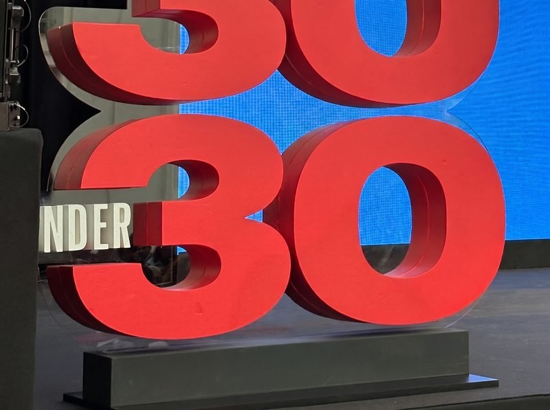The red “30 Under 30” letters on stage at the Forbes 30 Under 30 Summit 2024